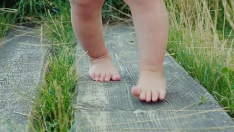 The first steps of a small child. Countryside Stock Footage 78856981