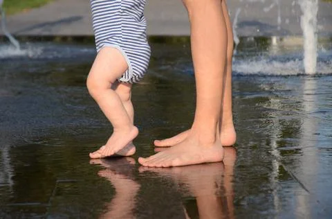 The first steps of a small child with mom Stock Photos