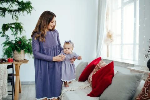 The first steps of a small child. Moms care. Stock Photos