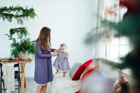 The first steps of a small child. Moms care. Stock Photos