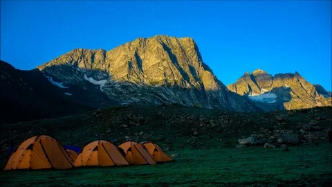 First sunlight on himalayan mountain with a campsite Stock Footage 104072139