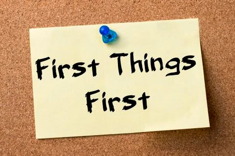 First Things First - adhesive label pinned on bulletin board Stock Photos