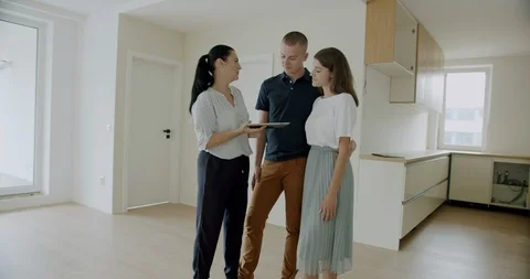First time buyers electronically signing digital tablet in new house. Stock Footage 120525442