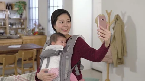 First time mother carrying her baby with carrier Stock Footage 158103875