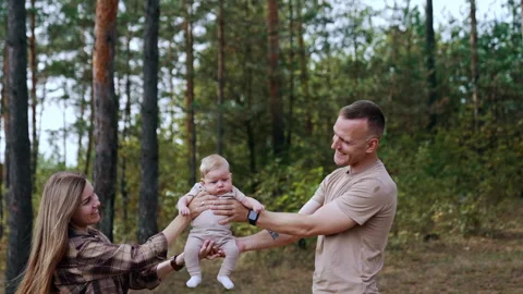 First time parents holding their son from two sides.  Stock Footage 252330007