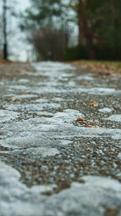 First traces of ice on an outdoor path, subtle seasonal transition Stock Footage 325830809
