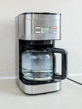 The first use of drip-type coffee maker should be with water without coffee Stock Photos