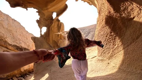 First view of one happy beautiful girl holding hand of her boyfriend walking and Stock Footage 249685568