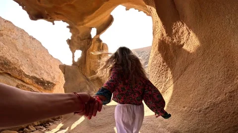 First view of one happy beautiful girl holding hand of her boyfriend walking and Stock Footage 249685831