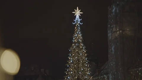 First, we see people walking around the old town among Christmas illumination Video stock 108519127