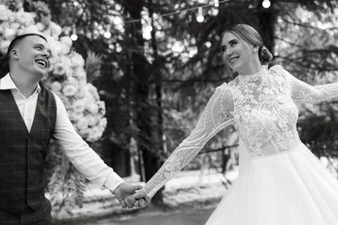 The first wedding dance of the bride and groom on a green meadow Stock Photos