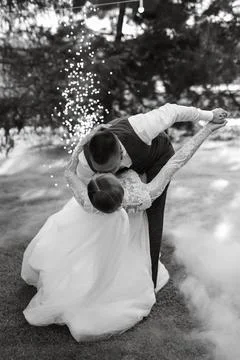 The first wedding dance of the bride and groom on a green meadow Stock Photos