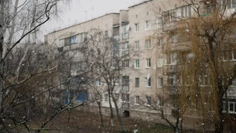 First winter snow falling with big white snowflakes in the city  Stock Footage 260473664