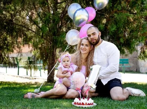 First year of life. birthday. happy parents. family photo shoot. cake. a part Photos