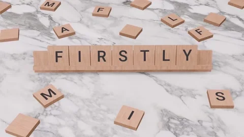 FIRSTLY word written on scrabble Video stock 257398605