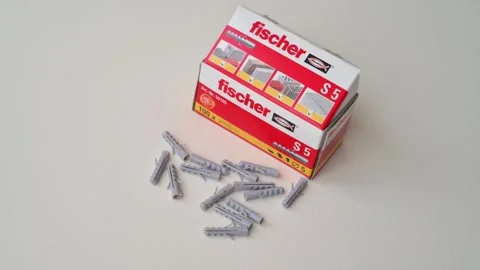 Fischer S5 Wall Plugs and Concrete Anchors Box with Loose Grey Plugs on White Stock Footage 325417984