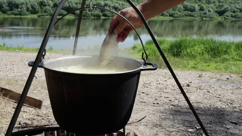 Fish is added to the cauldron with boiling fish soup against the backdrop of a Stock Footage 157456855