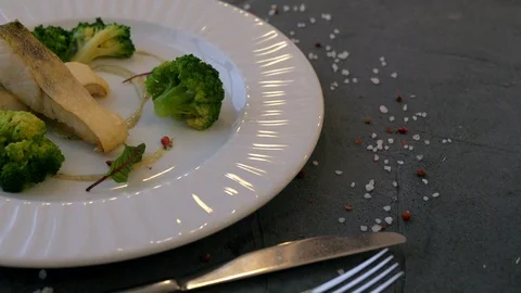 Fish and broccoli on the white plate on the grey background. Stock Footage 104057777