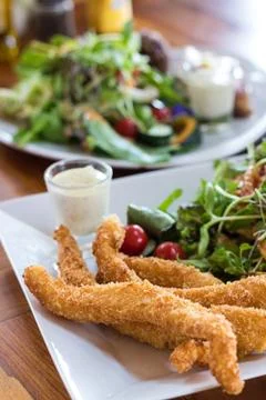 Fish and chips Deep fried battered fish on a plate with chips close up and .. Fotos de archivo