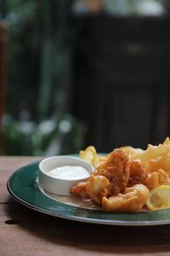Fish and chips fried fish and potatoes on wood background vintage style Stock Photos