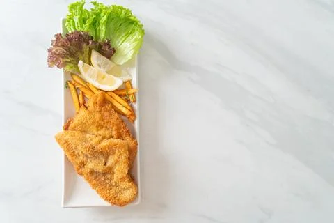 Fish and chips - fried fish fillet with potatoes chips Stock Photos