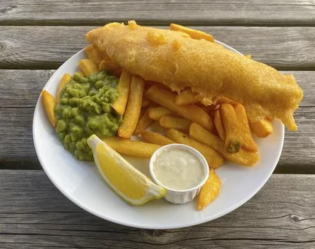 Fish and chips, fried fish in batter, french fries, pea puree, remoulade, lemon, Stock Photos