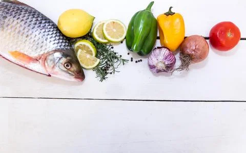 Fish and vegetables with place for text Фото
