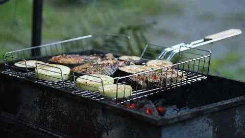 Fish and zucchini are roasted on a grill. Healthy food on the outdoor. Stock Footage 160896601