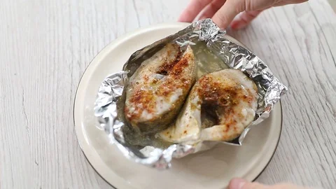 The fish baked in a foil with a lemon red chilli pepper Video stock 106774156
