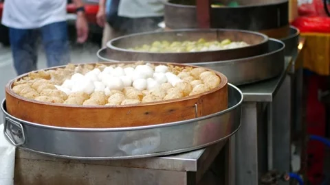 Fish balls and dim sum in bamboo steamer which is selling beside the street 動画素材 214634231