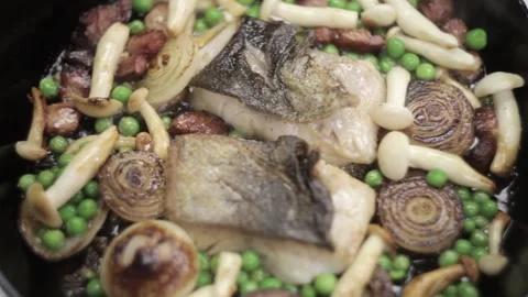 Fish being cooked with mushrooms and peas Stock Footage 307340055