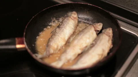 Fish is being fried on the frying pan Stock Footage 58514577