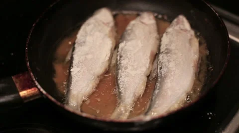 Fish is being fried on the frying pan. Close Up Stock Footage 58620855