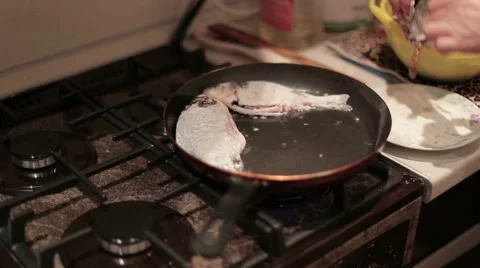 Fish is being fried on the frying pan. Close Up Stock Footage 60239029