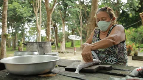 Fish being prepared by old lady Video stock 153097807
