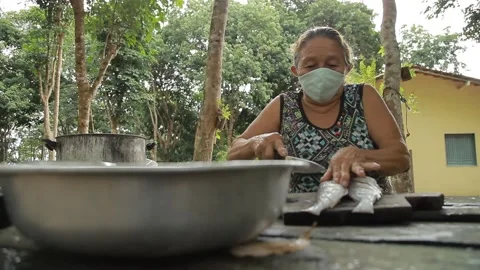 Fish being prepared by old lady Stock Footage 153097814