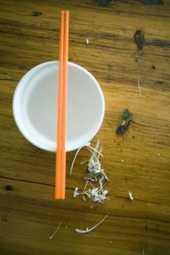 Fish bones on table next to bowl with chopsticks Stock Photos