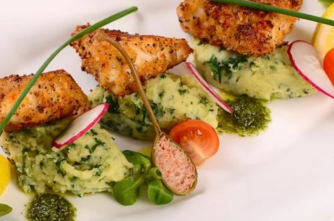 Fish in breadcrumbs with mashed potatoes Stock Photos
