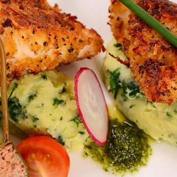 Fish in breadcrumbs with mashed potatoes Stock Photos