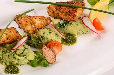 Fish in breadcrumbs with mashed potatoes Stock Photos