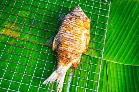 Fish burned, cooked and placed on green banana leaves,Top view Stock Photos