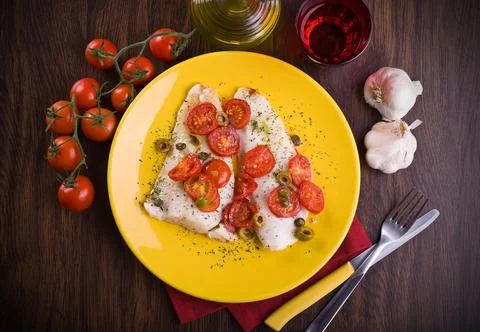 Fish with cherry tomatoes and olive Stock Photos