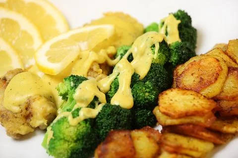 Fish, chips and broccoli Stock Photos