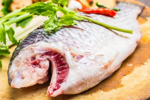 Fish on chopping block. Stock Photos