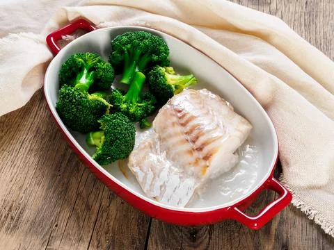 Fish cod baked in the oven with broccoli - healthy diet healthy food. Rusti.. Stock Photos