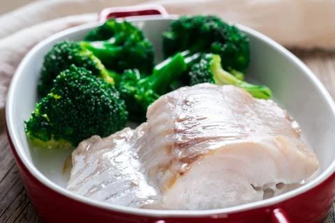 Fish cod baked in the oven with broccoli - healthy diet healthy food. Rusti.. Stock Photos