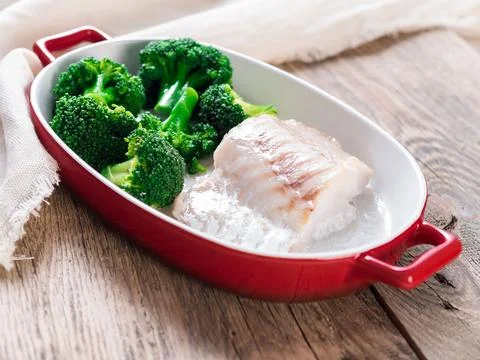 Fish cod baked in the oven with broccoli - healthy diet healthy food. Rusti.. Stock Photos
