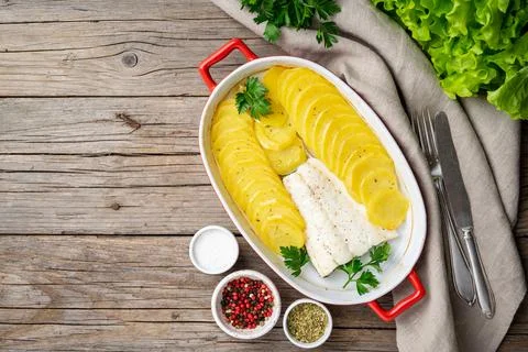 Fish cod baked in oven with potatoes and spice - healthy diet food. Stock Photos
