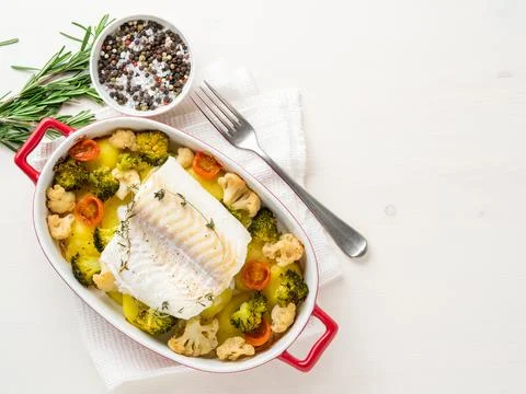 Fish cod baked in the oven with vegetables - healthy diet healthy food. Light Stock Photos