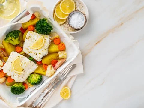 Fish cod baked in the oven with vegetables - healthy diet healthy food. Light Stock Photos